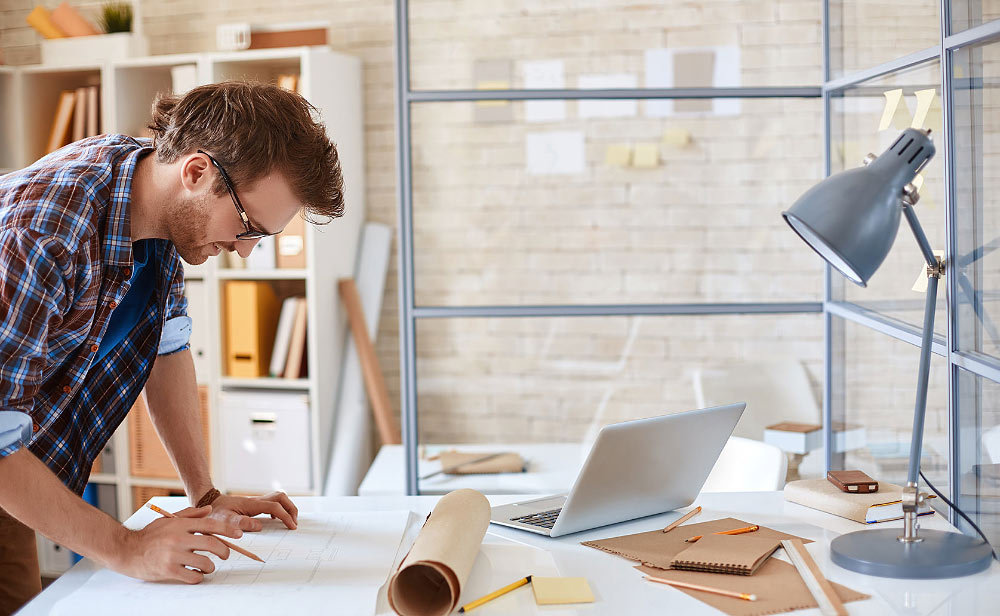 Person Working on Construction Plans